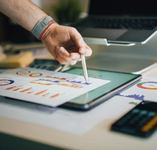 Website analytics charts reviewed on a tablet
